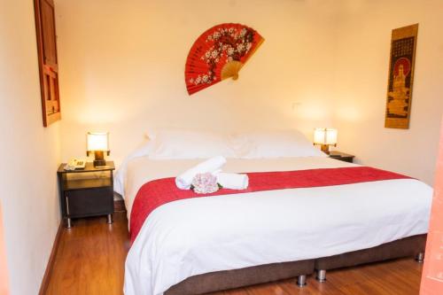 a bedroom with a bed with two stuffed animals on it at San Agustin Internacional Hotel in San Agustín