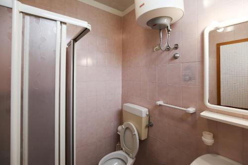 a bathroom with a toilet and a shower at Torcello in Bibione