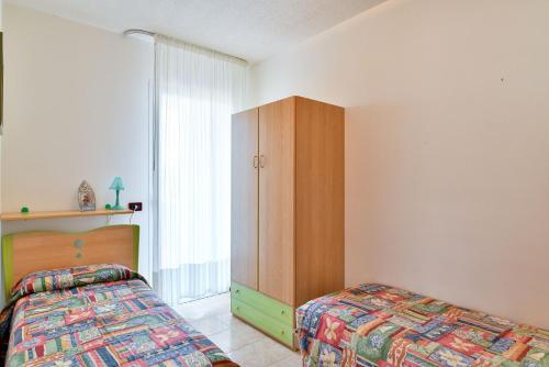 En eller flere senge i et værelse på Villaggio Lido del Sole