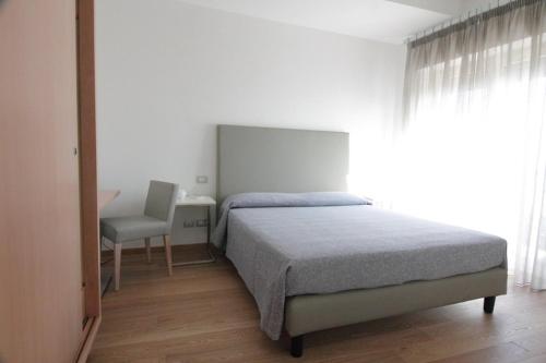 a bedroom with a bed and a desk and a chair at Belo Horizonte in Civitanova Marche