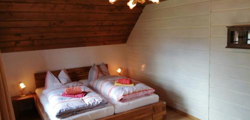 a bed in a room with two pillows on it at Heidi's Häuschen in Bad Mitterndorf