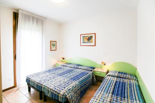 A bed or beds in a room at Lecci Lido Altanea