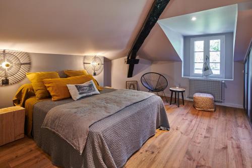 a bedroom with a large bed and a window at BEL AIR MAISON D'HOTES DES LANDES in Castets
