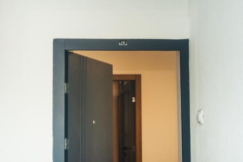 a mirror hanging on a wall in a hallway at Aparment Theatre in Niš