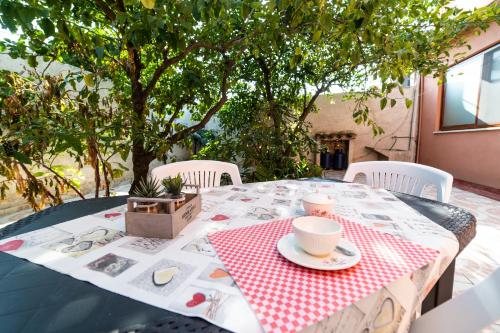 a table with a red and white checkered table cloth at Casa Diana P3115 in Riola Sardo