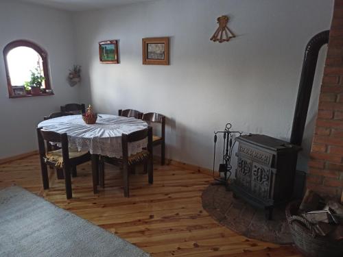 a dining room with a table and a stove at Mountain house in Mala Reka