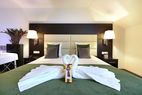 a hotel room with a bed with towels on it at Hotel Charleroi Airport - Van Der Valk in Charleroi