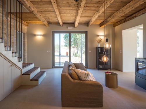 a living room with a couch and a staircase at Casale Tre Gelsi in Cingoli