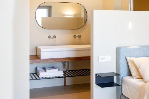 a bathroom with a sink and a mirror at Casale Tre Gelsi in Cingoli