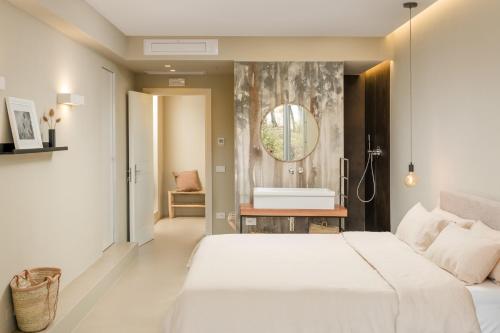 a bedroom with a white bed and a bath tub at Casale Tre Gelsi in Cingoli