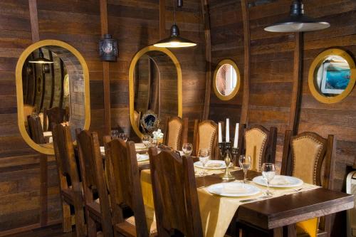 a dining room with a table and chairs and mirrors at Hotel Plaža in Omiš