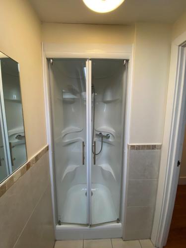 a shower stall in a bathroom with a mirror at Wendover Arms Hotel in High Wycombe