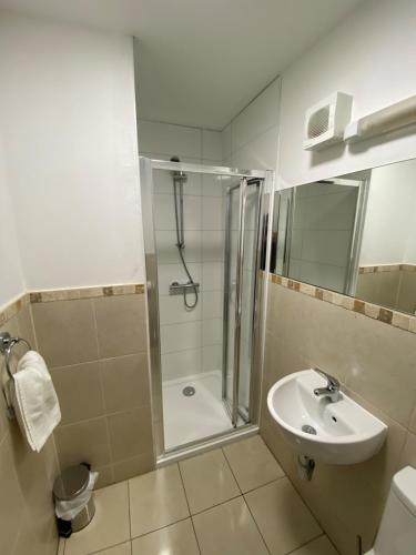 a bathroom with a shower and a sink at Wendover Arms Hotel in High Wycombe