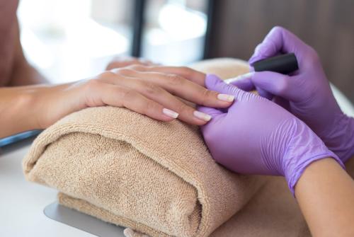 a woman getting a manicure at a nail salon at Hotel Plaža in Omiš