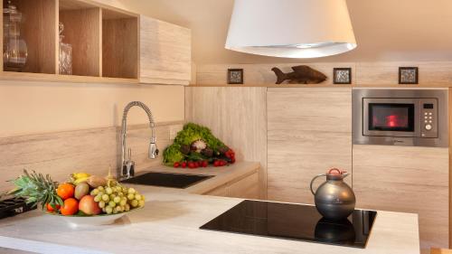 a kitchen with a bowl of fruit on a counter at Maison Amalia in Sorrento