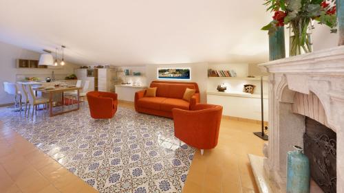 a living room with a couch and a fireplace at Maison Amalia in Sorrento