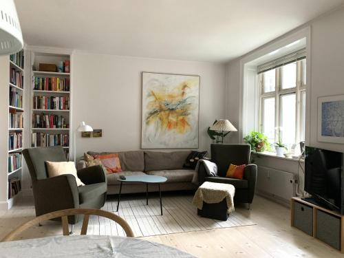 コペンハーゲンにあるApartmentInCopenhagen Apartment 547のリビングルーム(ソファ、椅子、テレビ付)