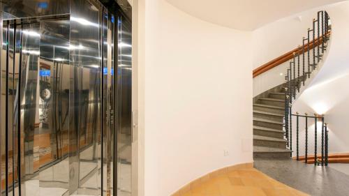 a staircase with glass railings in a building at Maison Amalia in Sorrento
