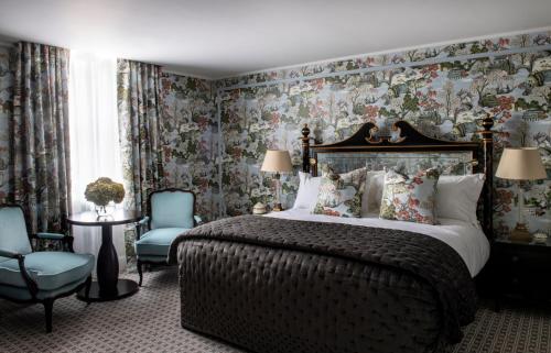 a bedroom with a large bed and floral wallpaper at The Kensington Hotel in London