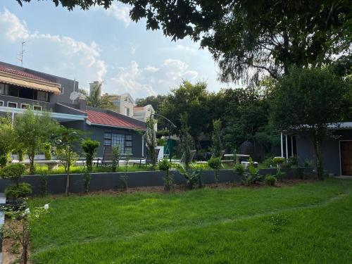 a garden in front of a house at Marion Lodge in Johannesburg