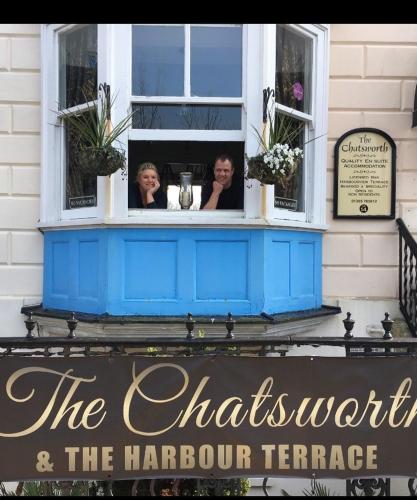 two women are looking out of a window at The Chatsworth in Weymouth