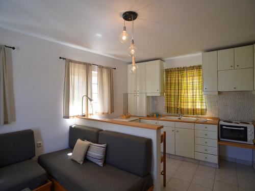 a kitchen with two chairs and a couch in a room at Granny's House in Palekastron