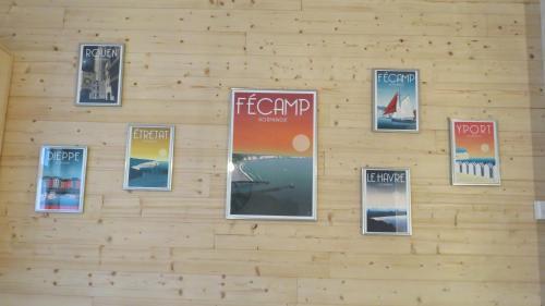 a wall with posters on a wooden wall at L'étape Normande in Fécamp