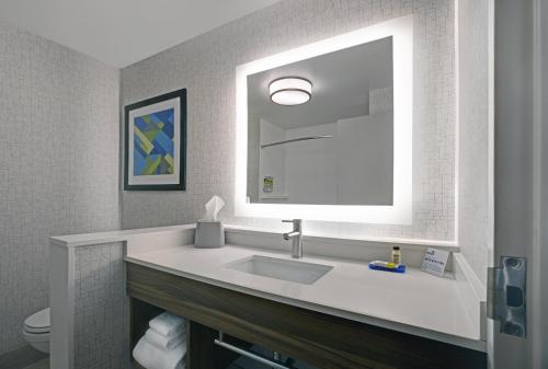 a bathroom with a sink and a mirror at Holiday Inn Express - Milwaukee Downtown by IHG in Milwaukee