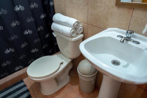 a bathroom with a toilet and a sink at Point Break Santa Teresa in Santa Teresa Beach