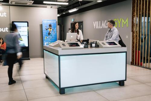 two people standing at a counter in a store at Village Hotel Southampton Eastleigh in Southampton