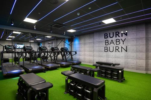 a gym with a bunch of chairs and green carpet at Village Hotel Southampton Eastleigh in Southampton
