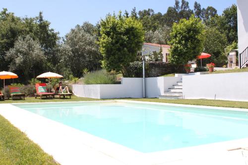 a swimming pool in the yard of a house at Casa nas Serras in Vila Nova de Poiares