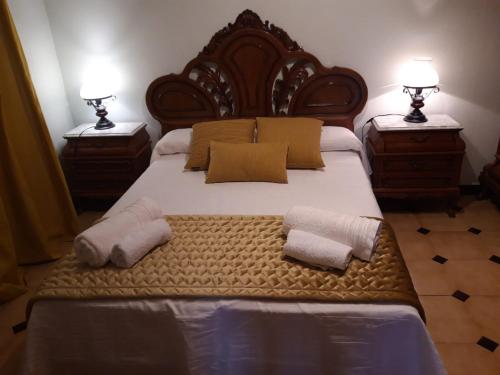 a bedroom with a large bed with two towels on it at Los Molinos in Valles de Ortega