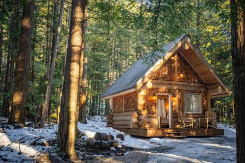 a log cabin in the woods in the snow at Boulder Mountain Resort in Revelstoke
