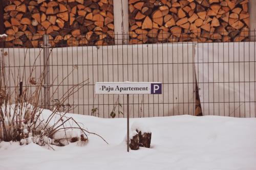 a sign that says pay apartment p in the snow at Paju Apartement with Sauna in Võru
