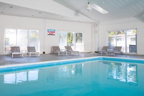 a swimming pool with blue water in a building at Endless Coast, A Boutique Hotel in Wellfleet