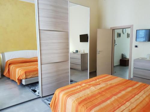 a bedroom with a bed and a mirror at Casa chic in Barletta