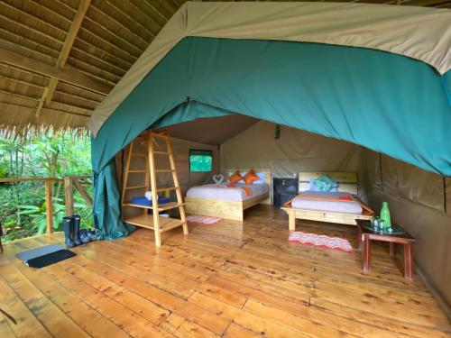 a tent with two beds and a ladder in it at Tami Lodge in Providencia