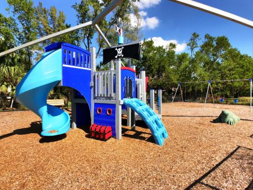 a playground with a blue and red slide at Siesta Heron Suites & Villas in Siesta Key