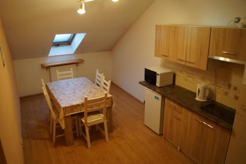 a kitchen with a table and chairs and a kitchen with a window at Na Starówce in Żywiec