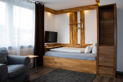 a bedroom with a bed and a tv and a couch at LuPartment in Ludwigshafen am Rhein