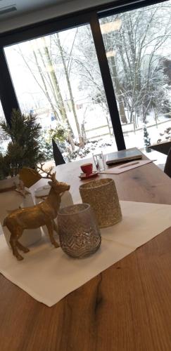 a table with a figurine of a deer on it at Haidinger's Boutique Domizil in Oftering