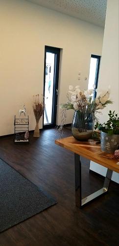 a room with a table with a vase of flowers on it at Haidinger's Boutique Domizil in Oftering