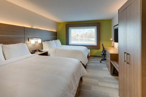 a hotel room with two beds and a window at Holiday Inn Express - Cincinnati North - Monroe by IHG in Monroe