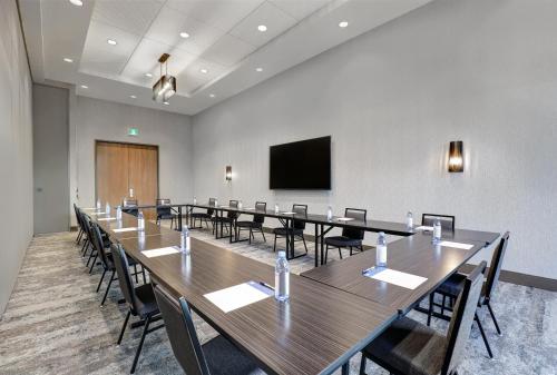 a conference room with tables and chairs and a flat screen tv at Holiday Inn Express - Kingston West by IHG in Kingston