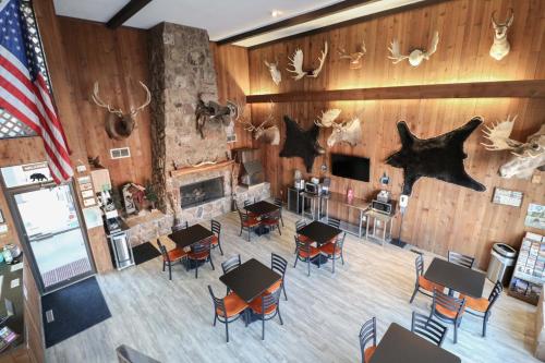 an aerial view of a room with tables and chairs at Bear Lodge Motel in Sundance