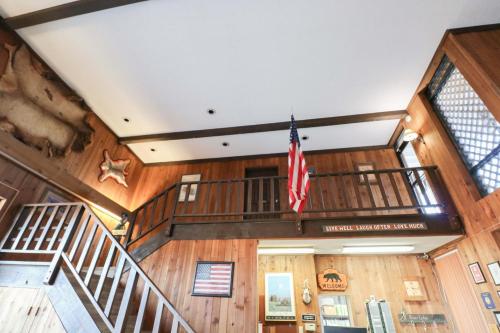a room with a staircase and an american flag at Bear Lodge Motel in Sundance