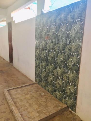 a wall with a mural of palm trees on it at Casa de Veraneio Ilha de Itamaracá in Itamaracá
