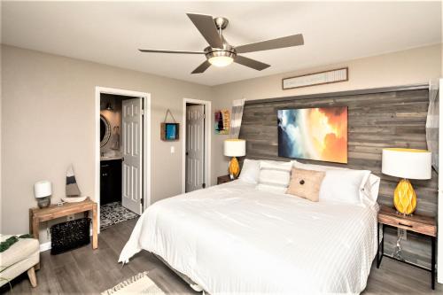 a bedroom with a white bed and a ceiling fan at NEW! Family Lake Havasu Home Close To Off-Roading And London Bridge! in Lake Havasu City