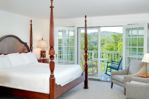 a bedroom with a bed and a balcony at The Shire Woodstock in Woodstock